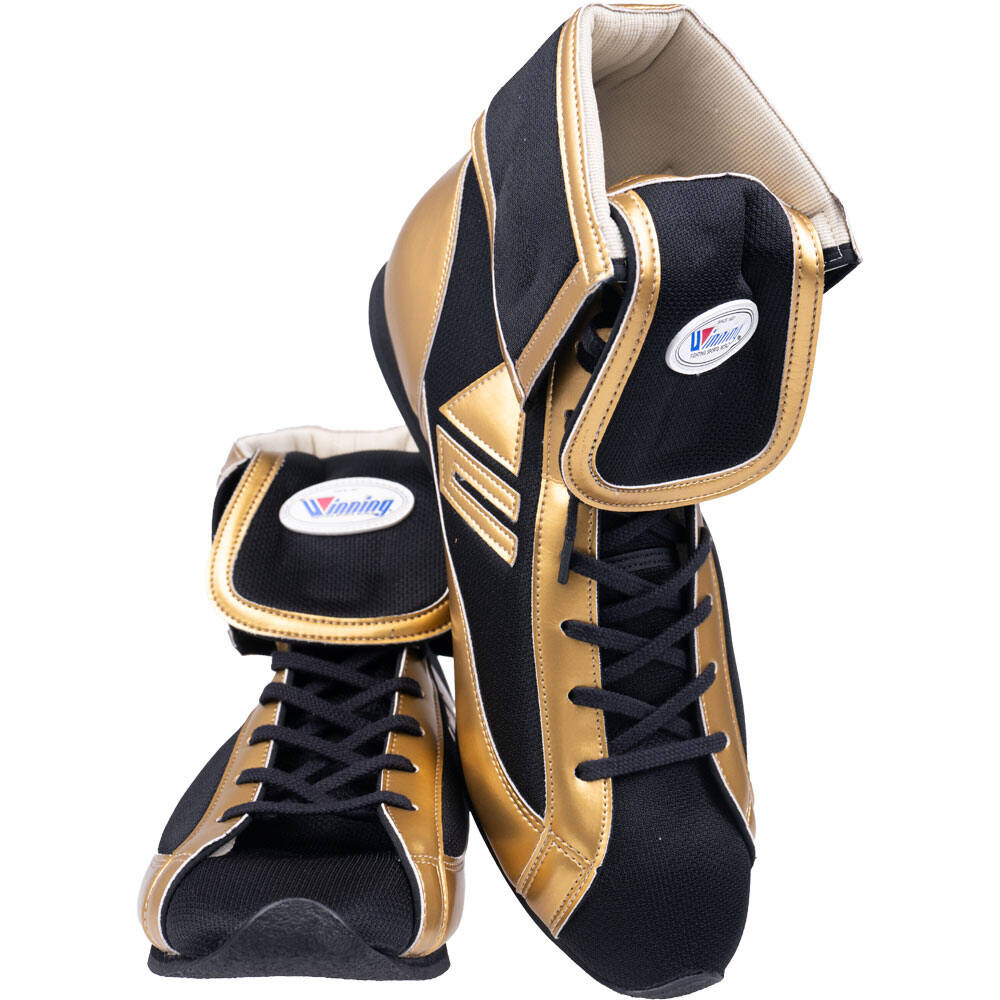 Pair of Winning short-cut boxing boots in black and metallic gold with lace-up front and Winning brand logo patch on ankle strap