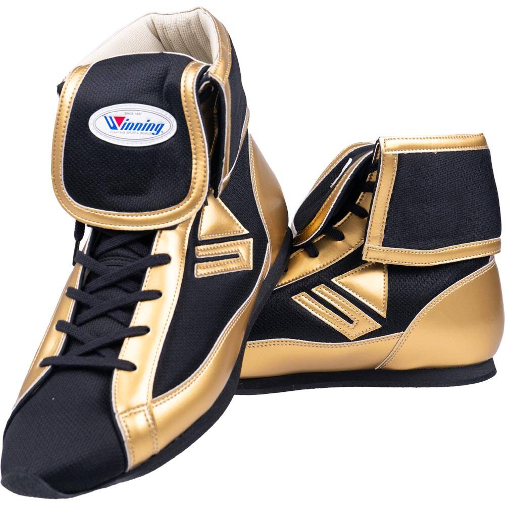Winning short-cut boxing shoes in gold and black with fold-over ankle collar displaying Winning brand oval patch