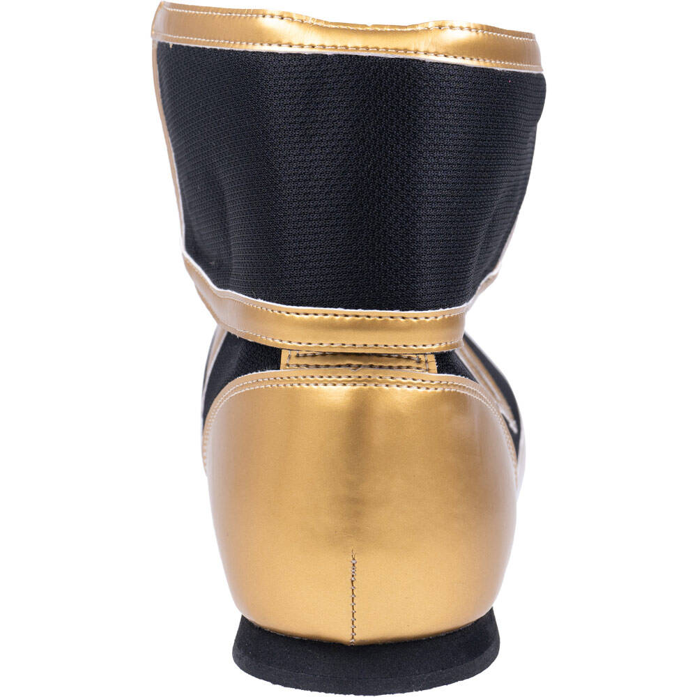Winning short-cut boxing boots in metallic gold and black angled view