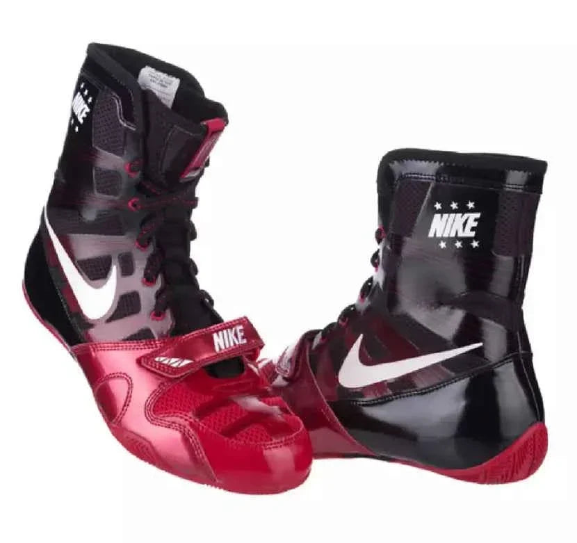 Front three-quarter angle of pair of black and red Nike Hyperko 1 boxing boots showing lacing and white Swoosh
